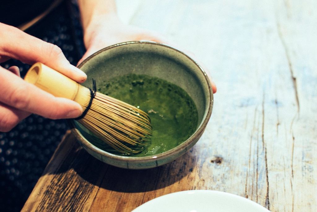 Matcha being whisked in a ceramic bowl